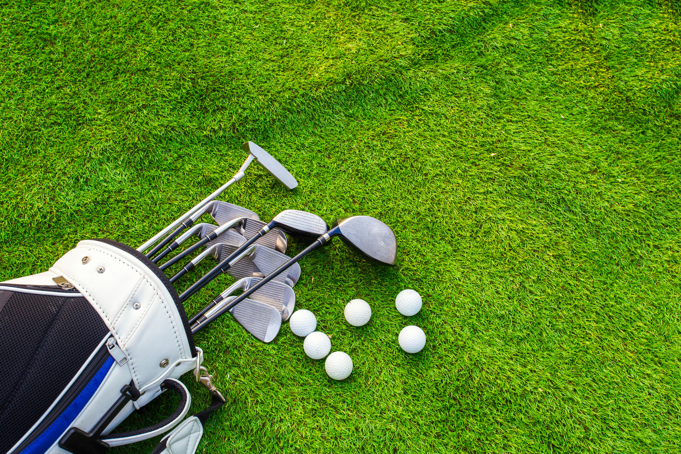 Golf Club and Balls on Grass Field
